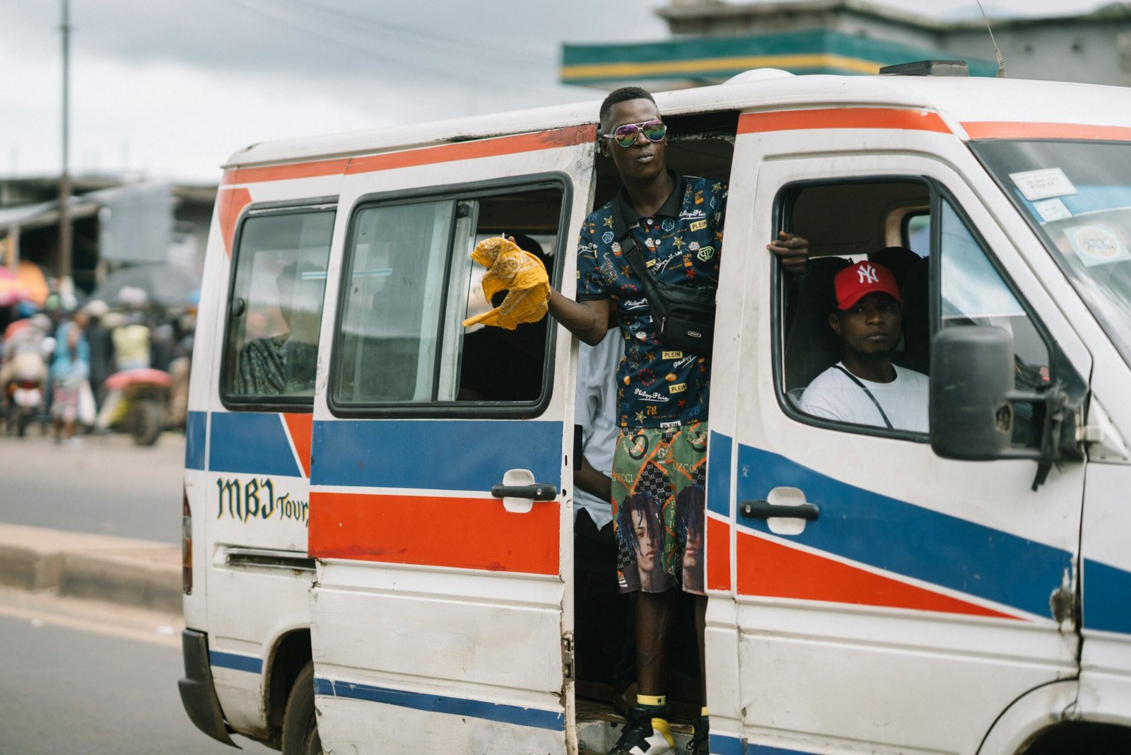 Yound man on a taxi bus in the city